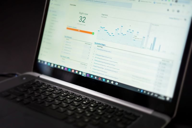 Laptop showing an analytics dashboard with charts, used to track how a blog post performs